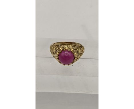 A gold coloured ring set with a pink cabochon, 8.8gLocation: 