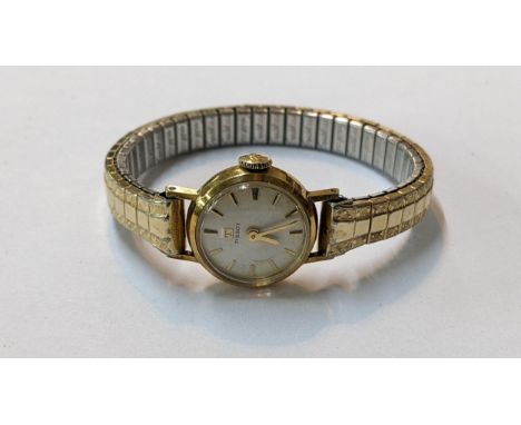 A vintage Tissot 9ct gold manual wind wristwatch on a gold plated expanding braceletLocation: 