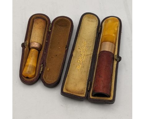 A Cheroot holder A/F having an amber coloured mouth piece and a 9ct gold band, together with a cigar holderLocation: 