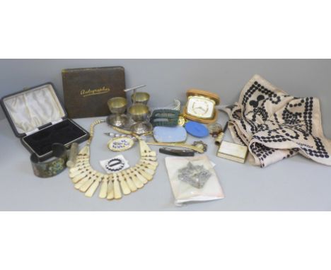 A collection of vintage items including a travel clock, egg cups, a buckle, a book containing hand written poems, etc., a sca