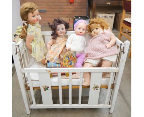 Four dolls; circa 1947 doll with red hair, a 1940s British doll with black wig, a 'Walkie Talkie' doll, one other, a push alo