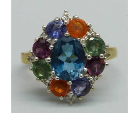 A silver gilt, multi gem cluster ring including topaz, apatite, iolite, garnet and fire opal, S 