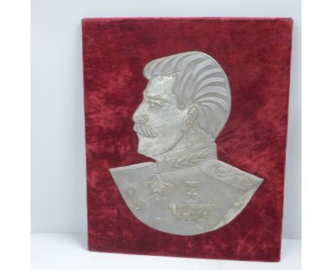 A mounted tin plate profile portrait of Joseph Staliln 