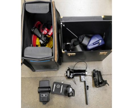 A Canon T50 35mm SLR camera, various remote triggers, flash gun, accessories, Polaroid camera, etc. **PLEASE NOTE THIS LOT IS