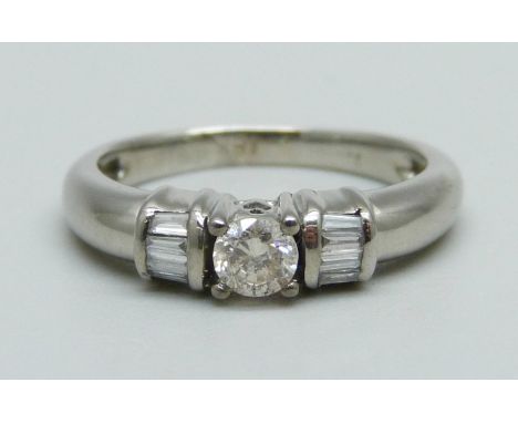 An 18ct white gold and diamond ring, 4.2g, M, centre stone approximately 0.25ct weight 