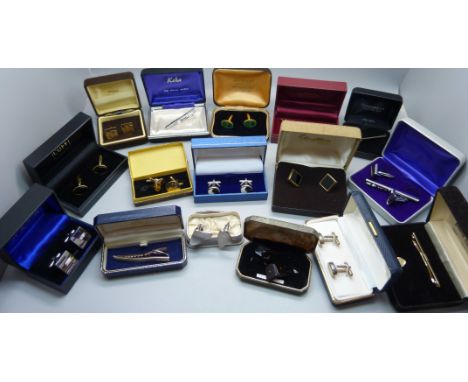 A collection of cufflinks and tie-pins, boxed