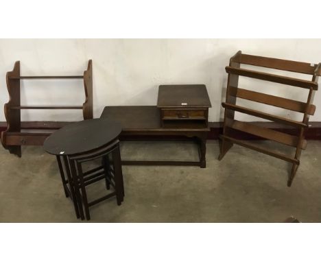 An oak telephone seat, mahogany nest of tables, wall hanging shelf and a beech bookcase