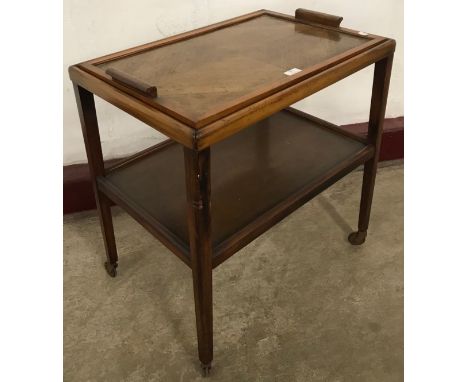 An Art Deco walnut two tier cocktail trolley 