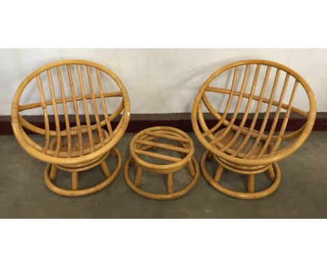 A pair of bamboo revolving conservatory ball chairs and a footstool 