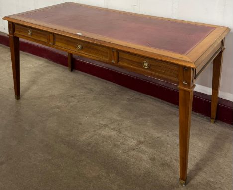 A French Empire style mahogany and red leather topped three drawer bureau plat 