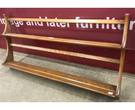 An Ercol Golden Dawn elm wall hanging plate rack 