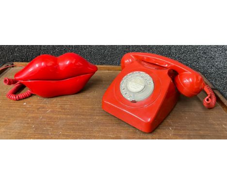 A red plastic telephone and a novelty lips telephone