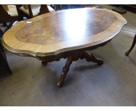 A Walnut Occasional Table, supported on decorative carved column and tripod base, 140 x 70 x 54.5 cms