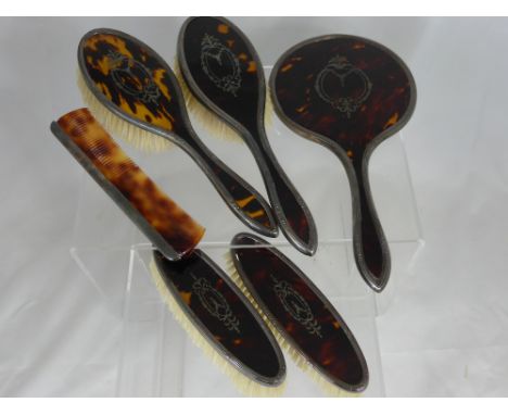 A Lady's Edwardian Silver and Tortoise Shell Dressing Table Set, comprising mirror, two hairbrushes, two clothes brushes and 