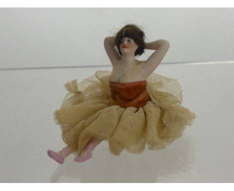 1920's German Bisque Bathing Beauty, depicted seated with arms held aloft, complete with period attire and chestnut wig.