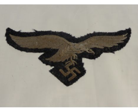 A German Nazi Luftwaffe Cloth Uniform Badge, together with a German U-Boat button a cap badge and a German Nazi Panzer Cloth 