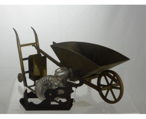 A Late 19th Century American Cast Iron Ink Well in the form of a snail together with a brassed metal luggage trolley match bo