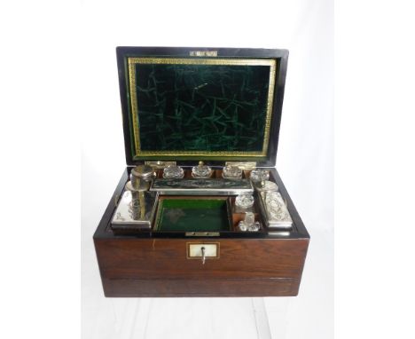 A Rosewood Ladies Vanity Box with fitted interior comprising three glass jars, five cut glass bottles and three rectangular t