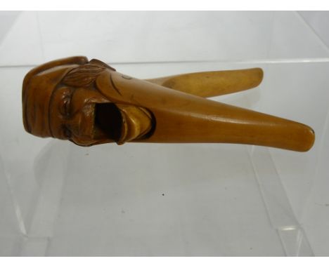 An Antique Continental Fruit wood Nutcracker, in the form of a jolly fellow.