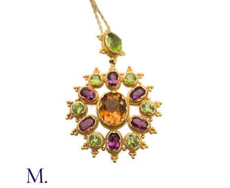 The 9ct yellow gold pendant is set with a large citrine together with peridots and amethysts. The pendant is suspended by. a 