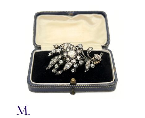 The centre of the antique gold and silver flower brooch is a rose cut diamond of approximately 5mm diameter; in the rest of t
