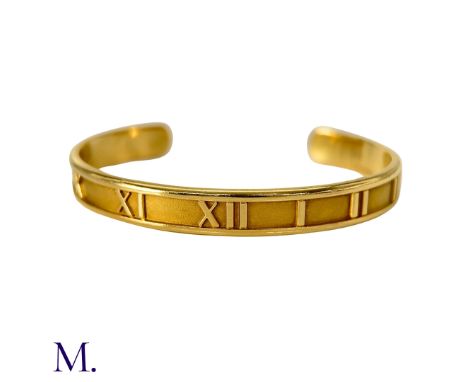 The vintage 18ct yellow gold Atlas Bangle by Tiffany & Co. is in the cuff style and measures 5.8cm across the internal diamet