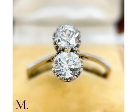 The 2-stone diamond ring is set with two high-quality old cut diamonds of approximately 1.0ct each. The band is marked with t