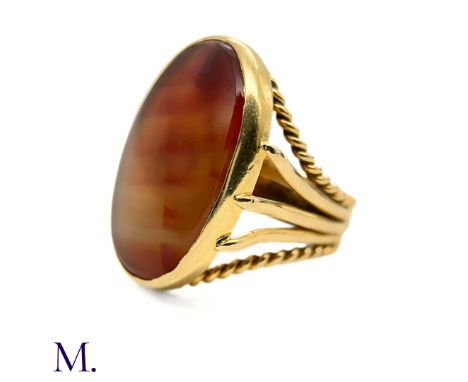 The large 18ct yellow gold signet ring is set with a colourful striated carnelian (approx. 26 x 20mm). The band is marked wit