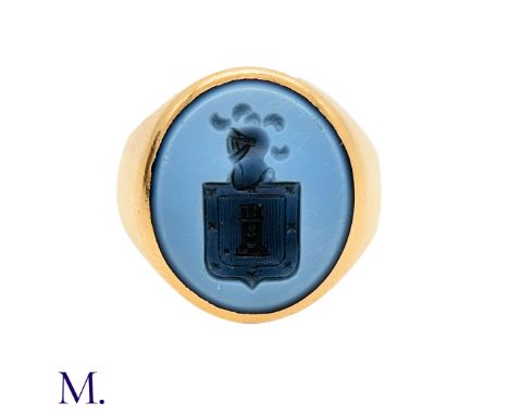 The gold signet ring is set with a carved agate depicting a shield and plumed helmet. The ring is not marked but tests indica