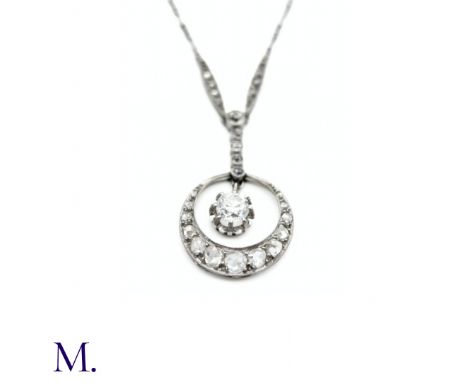 The platinum necklace comes together in a crescent pendant with a 0.45ct old cut diamond centre with rose cut diamonds in sur