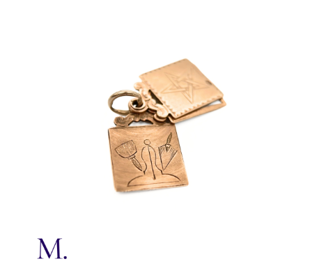 The 9ct rose gold charm is made up of three rectangular plates with engraved masonic designs. The charm is hallmarked for 9ct
