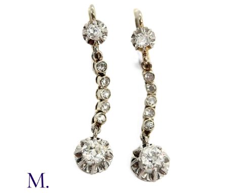 The 18ct white gold drop earrings are each set with an old cut diamond of approximately 0.50ct together with diamonds running