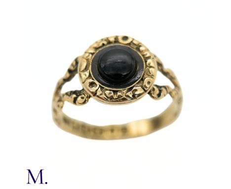 The 18ct gold ring is fully hallmarked and dated to 1823. It is set with a black stone to the centre and enamel surround.Weig