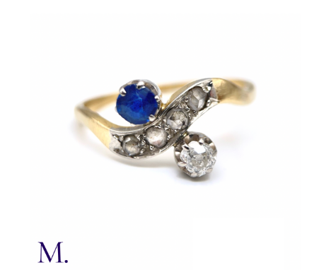 The 18ct gold ring is set with a 0.17ct old cut diamond and a 0.20ct old cut sapphire as well as a ripple of rose cut diamond