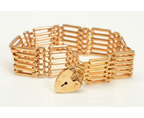 A 9CT GOLD GATE BRACELET, with heart padlock clasp and safety chain, chain with 9ct hallmark for Birmingham, clasp with 9ct h