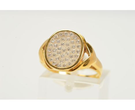 A GEM SET RING, of signet ring design, the oval glass panel set with circular colourless gems assessed as white sapphires to 