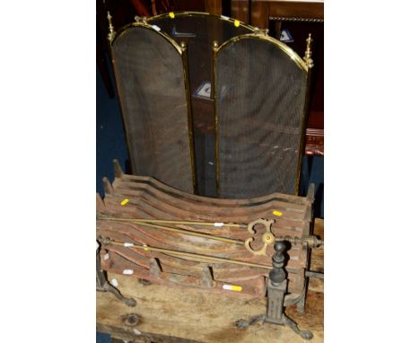 A 19TH CENTURY CAST IRON FIRE GRATE on a pair of fire dogs, two fire brass irons and a folding fire screen (5)