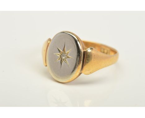 AN EARLY 20TH CENTURY 9CT GOLD DIAMOND SIGNET RING, designed as a single cut diamond within a star setting to the oval centra