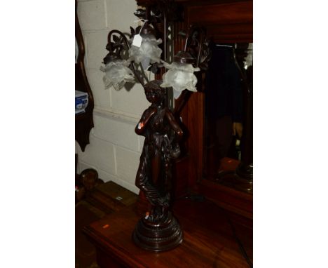 A REPRODUCTION FIGURAL RESIN TABLE LAMP with a triple branch light