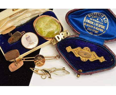 A SELECTION OF JEWELLERY, to include a pair of 9ct gold cufflinks, a 9ct gold dad ring, a 9ct gold Dolphin brooch, an oval 9c