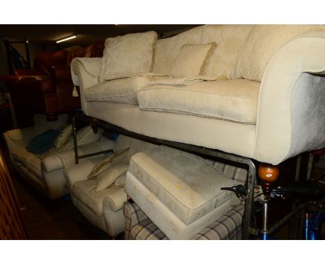 A PAIR OF CREAM UPHOLSTERED TWO SEATER SETTEES (one without back cushions), matching arm chair and pouffe together with a mod