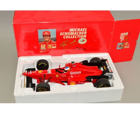 A BOXED MINICHAMPS 1/12 SCALE DIECAST MICHAEL SCHUMACHER COLLECTION FERRARI F310/2 GP ITALY 1996, model appears complete and 