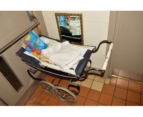 A VINTAGE SILVER CROSS PRAM together with linen table cloths, a Wirl a Gig wind operated garden ornament, vintage posters and