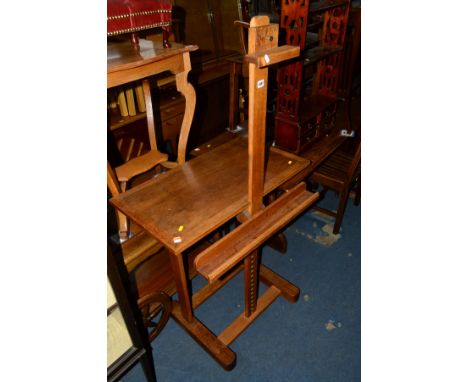 A GOLDEN OAK STUDIO EASEL with shelf behind