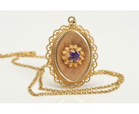 A 9CT GOLD AMETHYST PENDANT AND CHAIN, the pendant of oval outline with central circular amethyst on an engine turned panel w