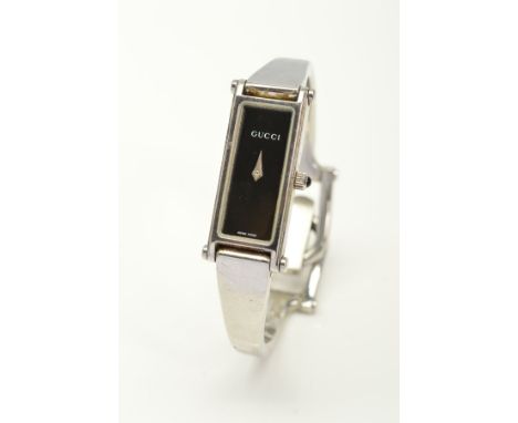 A GUCCI 1500L QUARTZ WRISTWATCH, black elongated rectangular dial with silvered hands, bangle style bracelet, width of case 1