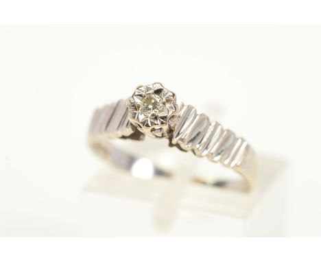 A 9CT WHITE GOLD DIAMOND RING, designed with a single brilliant cut diamond in an illusion setting, to the part textured band
