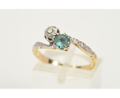 A GEM RING, designed with a single cut diamond within an illusion setting alongside a blue zircon in a cross over design, sta