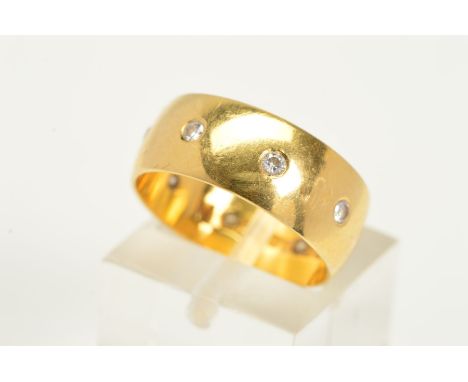 AN 18CT GOLD DIAMOND SET BAND RING, the yellow gold wide band flush set with eight brilliant cut diamonds, estimated total di