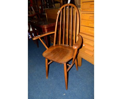 AN ERCOL ELM SPINDLE HOOP BACK ARMCHAIR (sd)